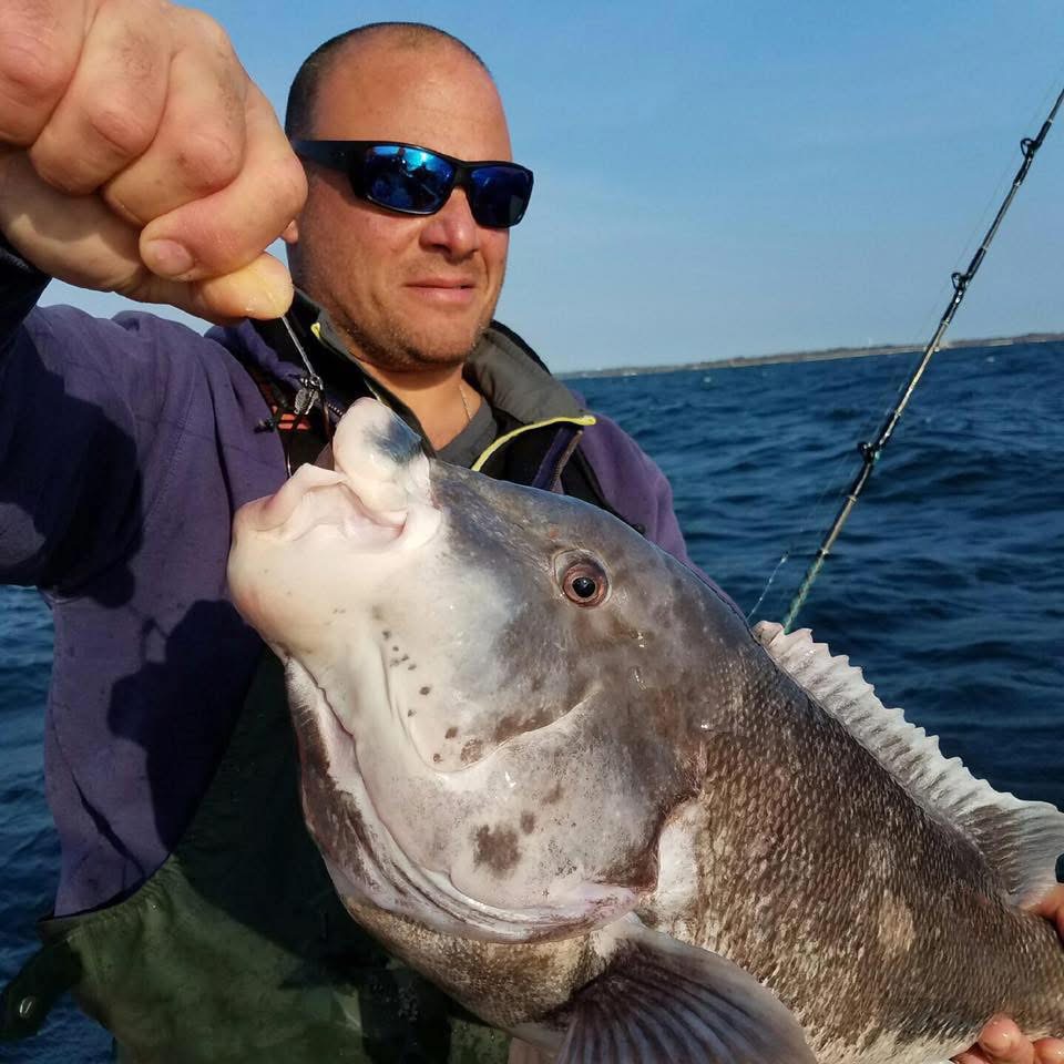 Nick holding a large blackfish caught offshore